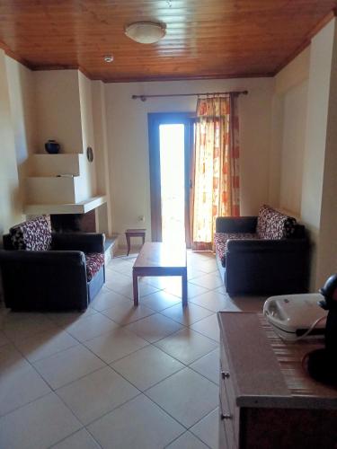 a living room with couches and a table at Guesthouse Kallisti in Anilio Pelion