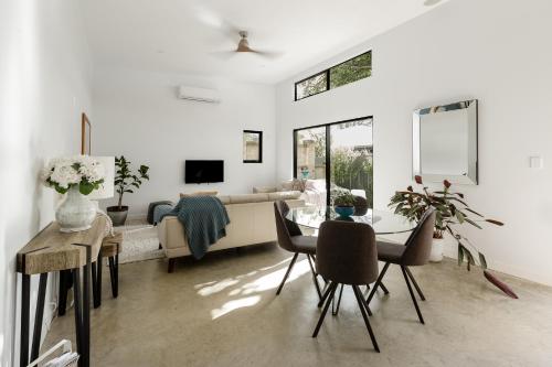 a living room with a couch and a table and chairs at Peppi Place - 2 Bedroom with Ensuites Town Villa in Margaret River Town