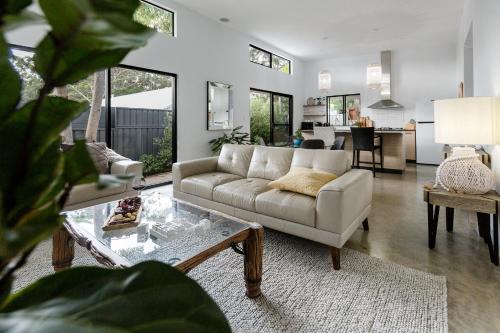 a living room with a couch and a table at Peppi Place - 2 Bedroom with Ensuites Town Villa in Margaret River Town