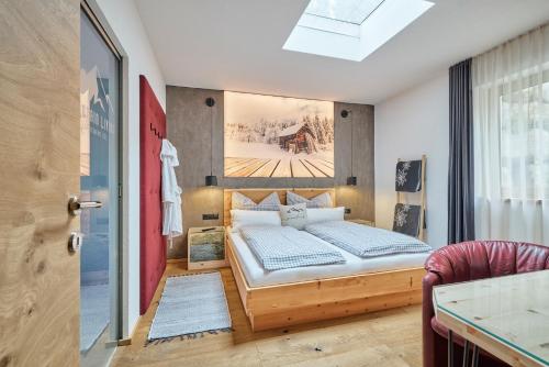 a bedroom with a bed with a painting on the wall at Mountain Living Ski-in & Ski out Silvretta Sommer Card Including in See