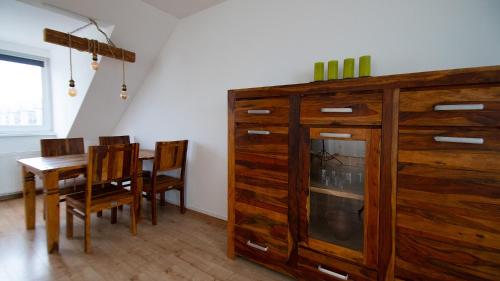 a dining room with a table and a large wooden cabinet at Rauszeit in Böhlen