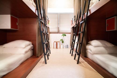 Ένα ή περισσότερα κρεβάτια σε δωμάτιο στο Hostel Casa Noda