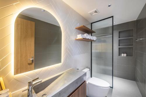 a bathroom with a sink and a toilet and a mirror at Anna's House Hotel in Hai Phong