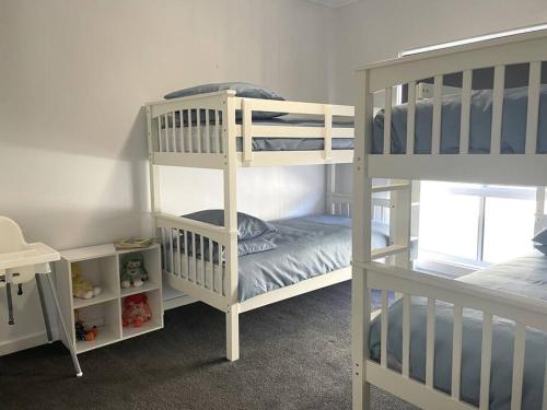 a room with two bunk beds and a bunk bed at Bunker View in Port Hughes
