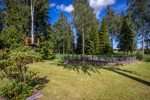 a playground in a park with a tree at Spa Glamping in Kirikumõisa