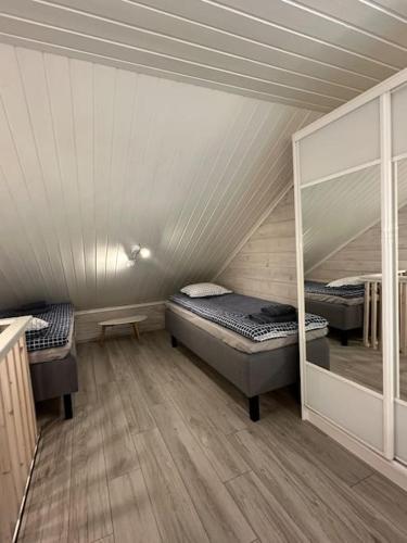 a room with two beds and a mirror in it at Leviki in Levi