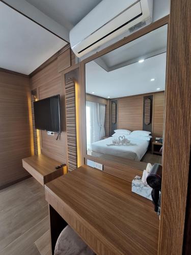 a bedroom with a bed and a large mirror at V.I.P BOUTIQUE HOTEL in Vientiane
