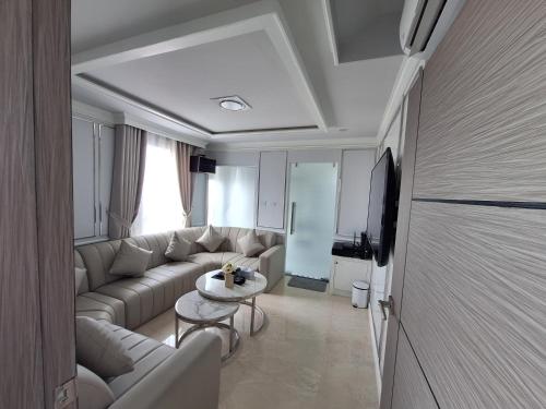 a living room with a couch and a table at V.I.P BOUTIQUE HOTEL in Vientiane