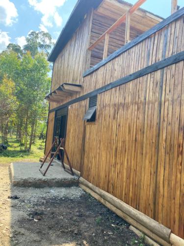a building with a wooden fence next to it at J and k villa in Fort Portal
