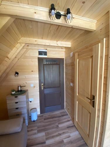 a room with a door in a log cabin at Podgora 1 in Žabljak