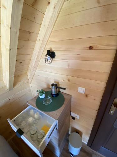 a tiny kitchen in a wooden cabin with a stove at Podgora 1 in Žabljak