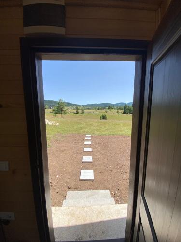 a view of a field from a window of a building at Podgora 1 in Žabljak