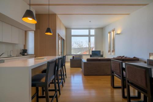a kitchen and living room with a bar and a couch at Forest Estate in Niseko