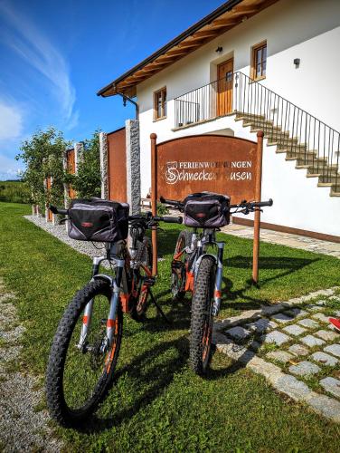 two bikes parked next to a sign in front of a building at Ferienwohnungen Schneckenhausen in Pittenhart