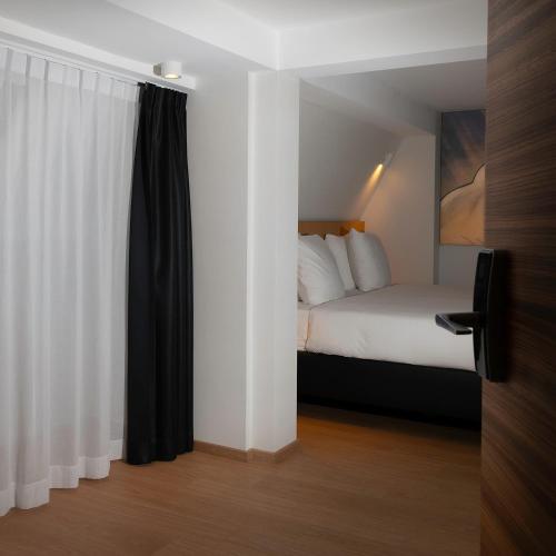 a hotel room with a bed and a window at Comic Art Hotel in Ghent