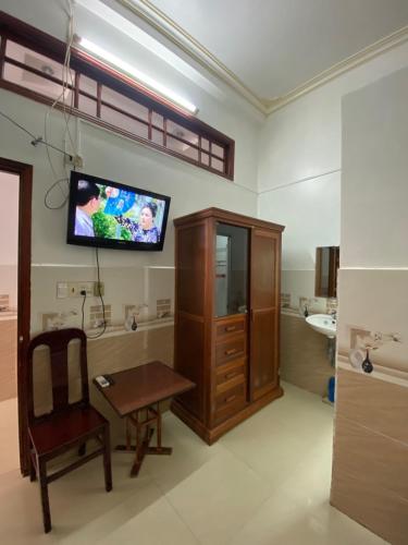 a living room with a tv on a wall at Thanh Tâm Hotel in Can Tho