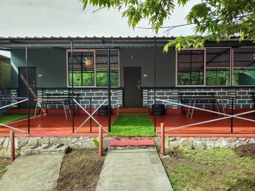 a building with a stage in front of it at Wild Tusker Homestay Masinagudi by LexStays in Masinagudi