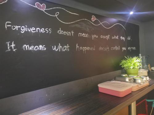 a chalkboard on a wall with a writing on it at Shanghai Fish Inn Bund in Shanghai