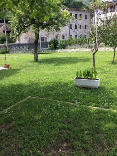 a park with a tree in the middle of a field at Villa Marga, private garden, patio, (shared) pool, 3 large bedrooms in Miane