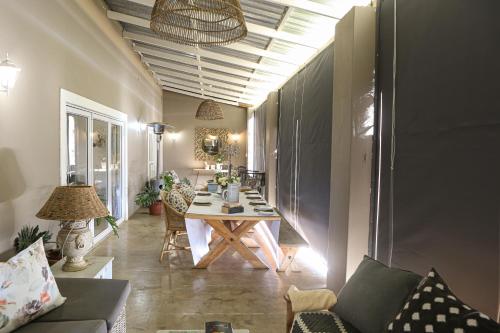 a living room with a table and a dining room at Springvale Farm in Nottingham Road