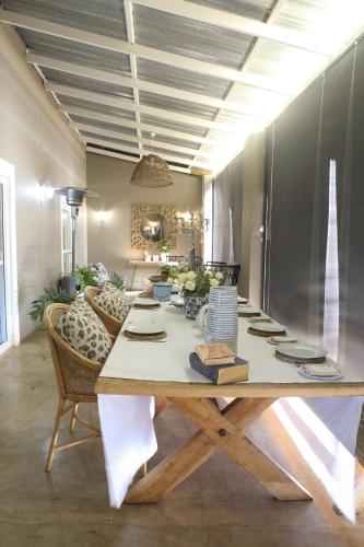 a large wooden table in a living room with chairs at Springvale Farm in Nottingham Road