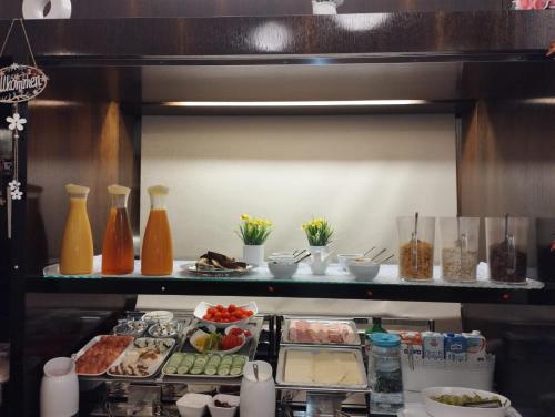 a kitchen with various food items on a shelf at Alma Boutique-Hotel in Vienna
