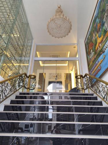 a staircase in a building with a chandelier at V.I.P BOUTIQUE HOTEL in Vientiane