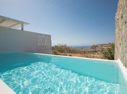 a swimming pool in a house with blue water at The Ammonite Resort in Super Paradise Beach