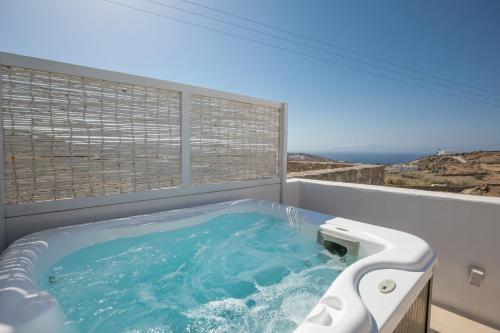 a hot tub in a room with a window at The Ammonite Resort in Super Paradise Beach
