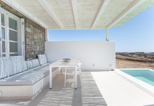 a patio with a table next to a pool at The Ammonite Resort in Super Paradise Beach