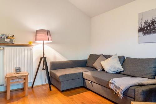 a living room with a couch and a lamp at Apt Morgensonne Zunerhof in Campodazzo