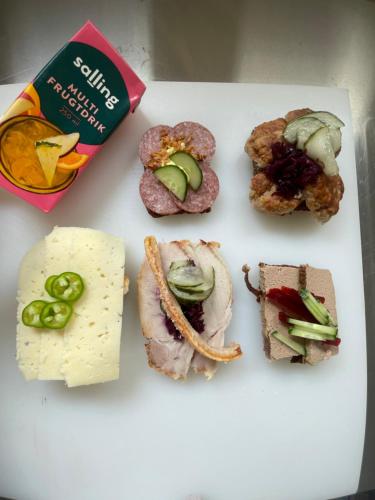 a white plate with different types of food on it at Hilmors Overnatning in Viborg