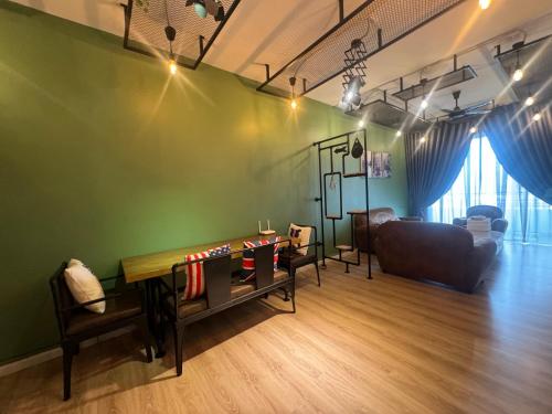 a living room with a table and a couch at The Majestic Imperial Tower Premium Suite - Ipoh in Ipoh