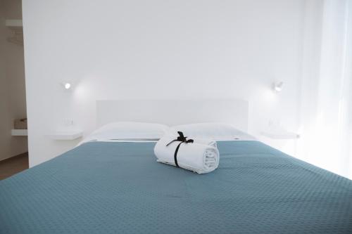 a white bed with a towel on top of it at Gioema in Borgo Vodice