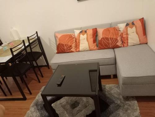a living room with a couch and a table at Condotel in Pasig City - Hampton Gardens in Manila