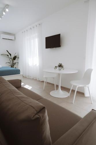 a living room with a couch and a table at Gioema in Borgo Vodice
