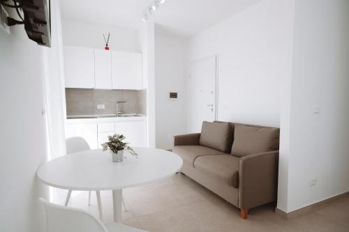 a living room with a couch and a table at Gioema in Borgo Vodice