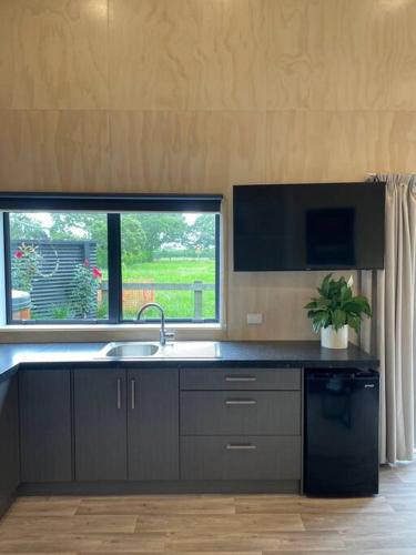 a kitchen with a sink and a window at LyeInn - Newstead Country Retreat in Newstead