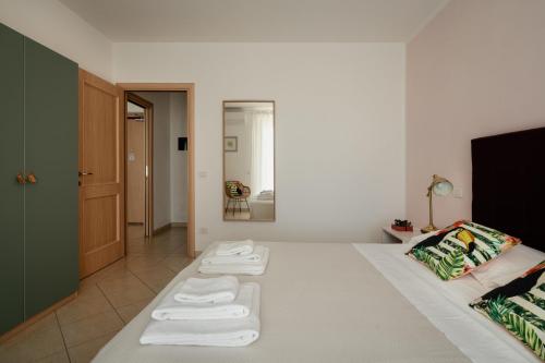 a room with a bed with towels on it at I Cinque Pini in Follonica