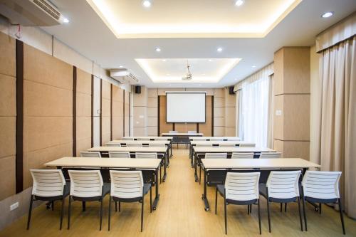 a classroom with tables and chairs and a whiteboard at Phavina Hotel Rayong SHA Extra Plus in Rayong