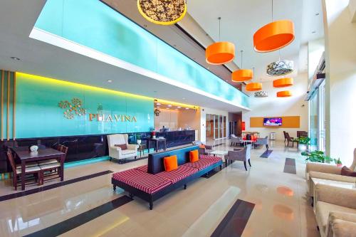 a lobby of a hotel with a couch and chairs at Phavina Hotel Rayong SHA Extra Plus in Rayong