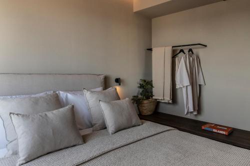 a bedroom with a bed with pillows and a closet at Ela Tinos in Arnados