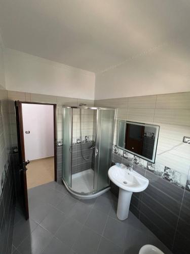 a bathroom with a shower and a sink at Armando's wooden roof in Berat