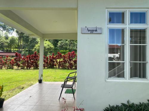 a porch of a house with a window and a chair at A beautiful and Spacious Rumah Manado 2 Bedrooms with Bathrooms Villa Marion Tomohon in Tomohon