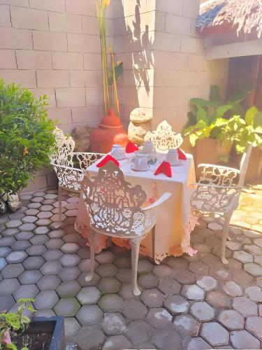 a table and chairs sitting on a patio at Hidden Tourist Inn in Abu