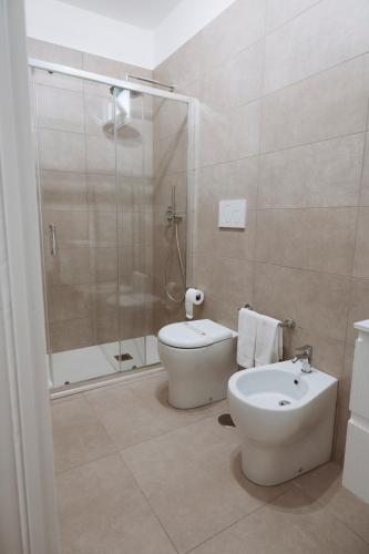 a bathroom with a shower and a toilet and a sink at Gioema in Borgo Vodice