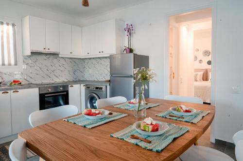 a kitchen with a wooden table with fruit on it at Nikis Village in Poros