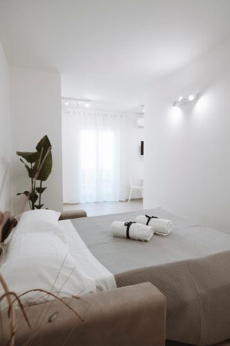 a white room with a bed with two pillows on it at Gioema in Borgo Vodice