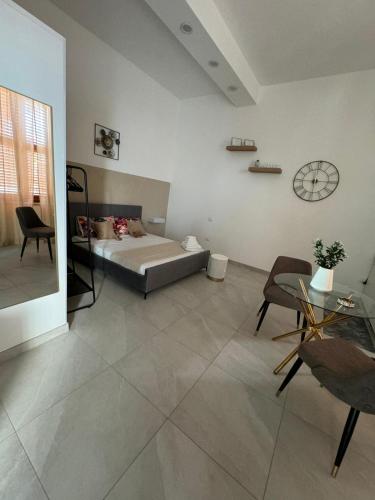 a bedroom with a bed and a table and chairs at B&b Sant'Anna in Ercolano