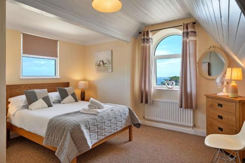 a bedroom with a bed and a large window at Finest Retreats - No 11 Porthminster in St Ives